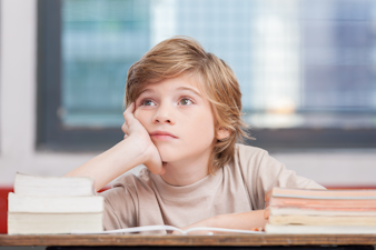 Boy daydreaming while reading