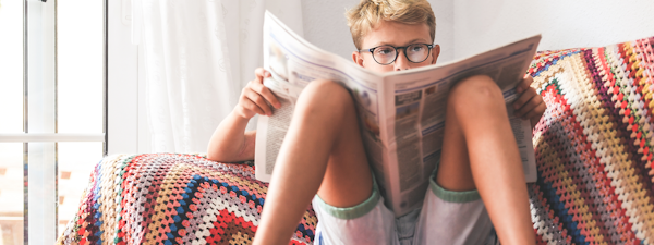 Boy reading a newspaper