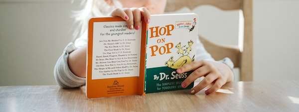 Young girl reading Dr. Suess Hop on Pop