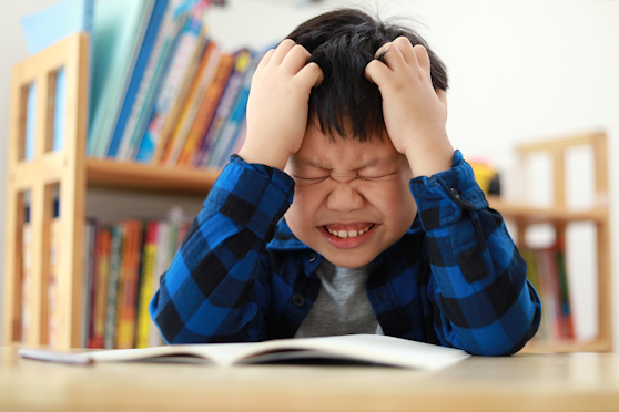 Young boy struggling with reading