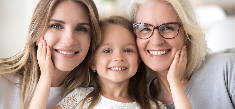 A daughter, mother, and grandmother smiling